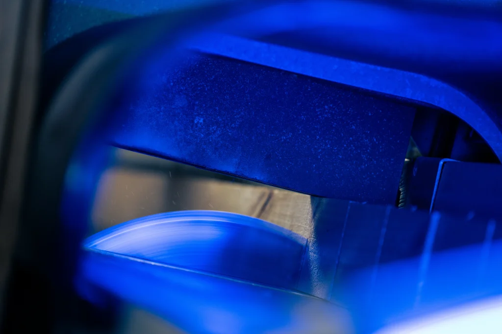 Close-up of industrial saw cutting timber for export packaging.