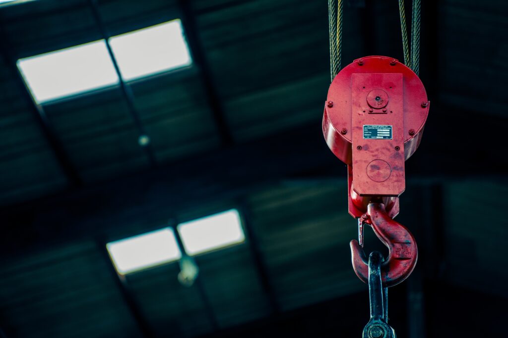 Overhead lifting hook used for heavy lifting in the warehouse.