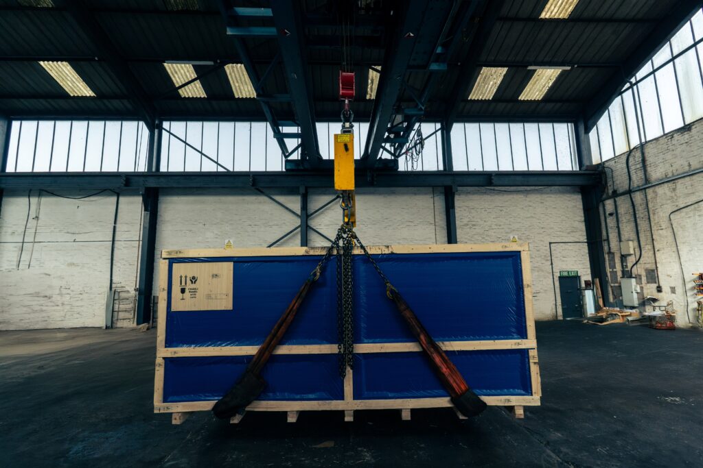 Overhead crane lifting a bespoke timber export case.