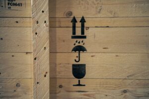 Fragile and handling symbols marked on timber export crate for international shipping